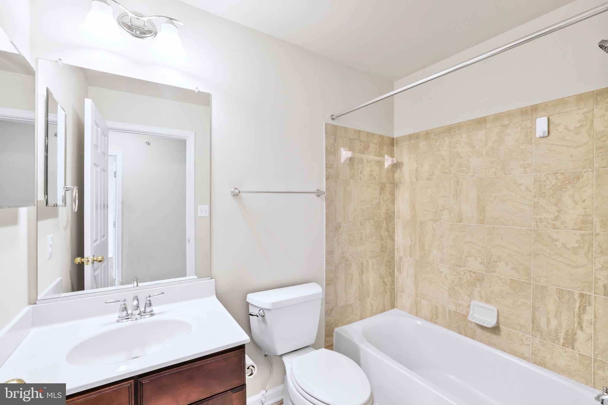 6055 Wicker Lane, Unit 128 Centreville, VA 20121 - Photo 30 of 36 a bathroom with a sink toilet and shower