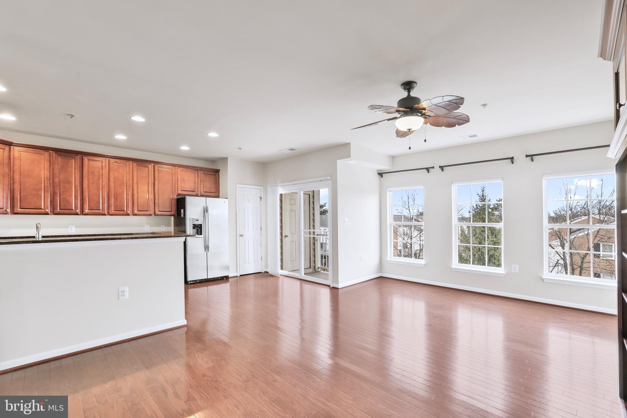 6055 Wicker Lane, Unit 128 Centreville, VA 20121 - Photo 3 of 36 a view of an empty room with a window and wooden floor