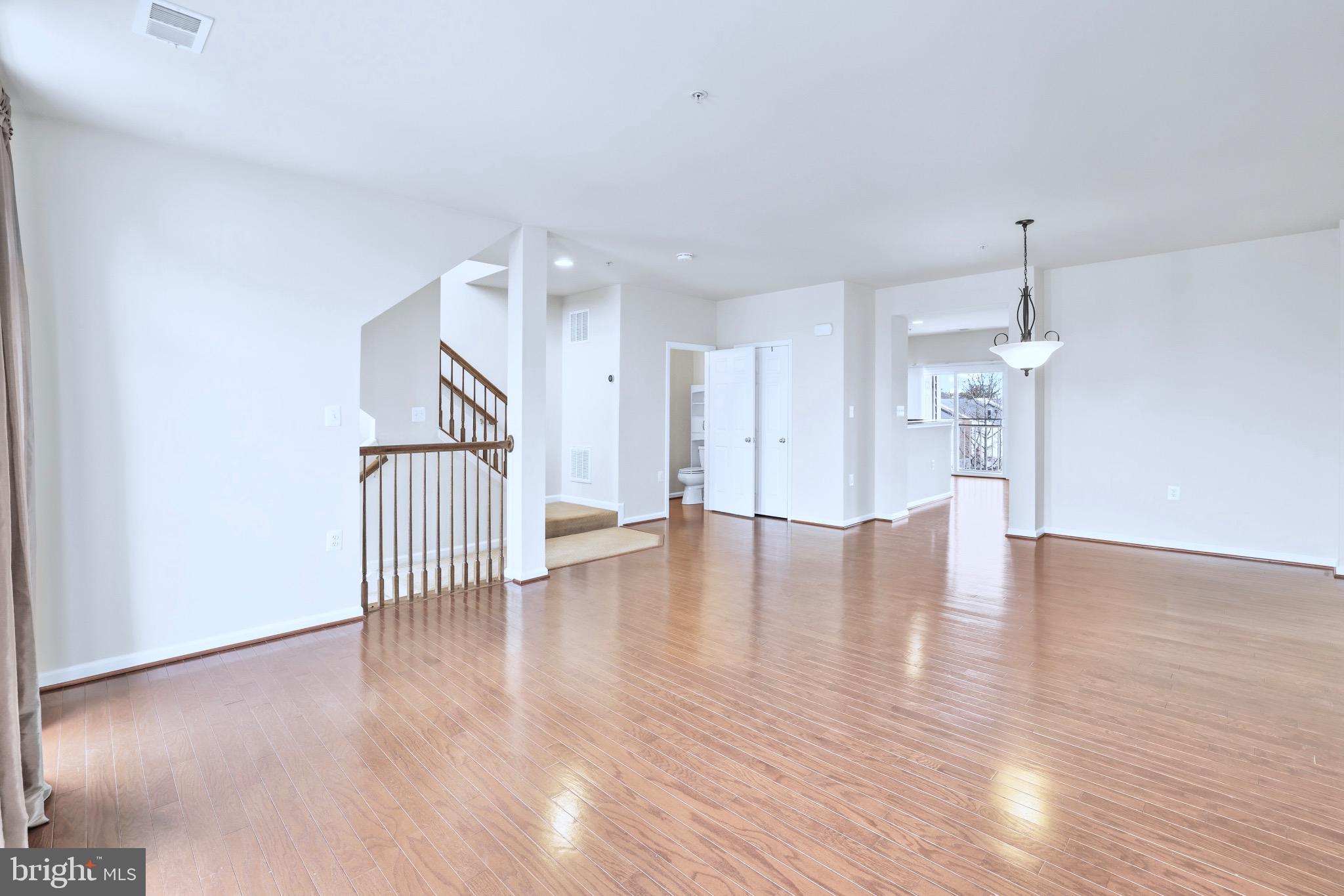6055 Wicker Lane, Unit 128 Centreville, VA 20121 - Photo 8 of 36 a view of a livingroom with wooden floor and stairs