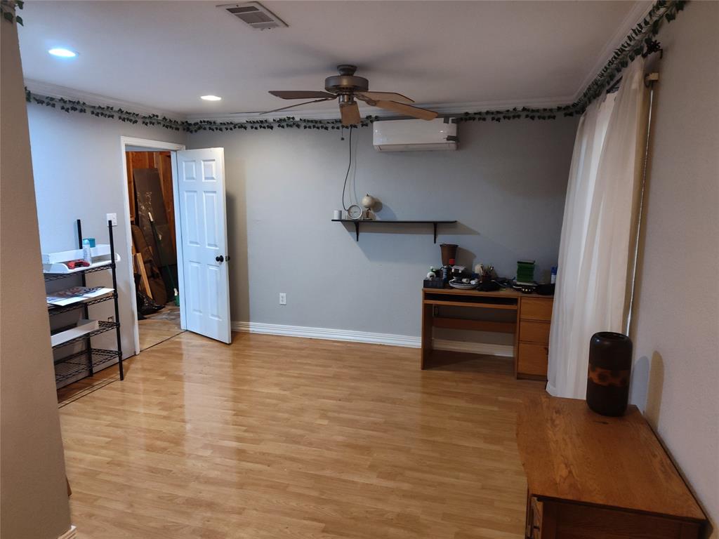 5077 East Line Road Whitewright, TX 75491 - Photo 4 of 16 a view of a room with wooden floor and cabinets