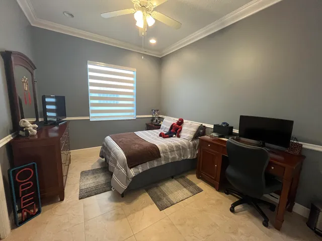 a bedroom with a bed and a chandelier
