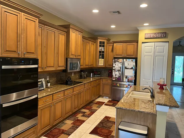 a kitchen with sink refrigerator and microwave