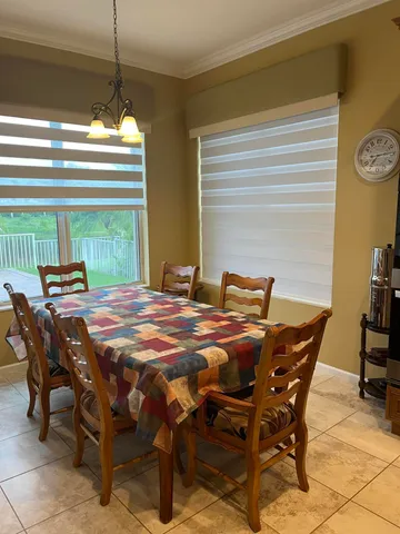 a dining room with furniture and window