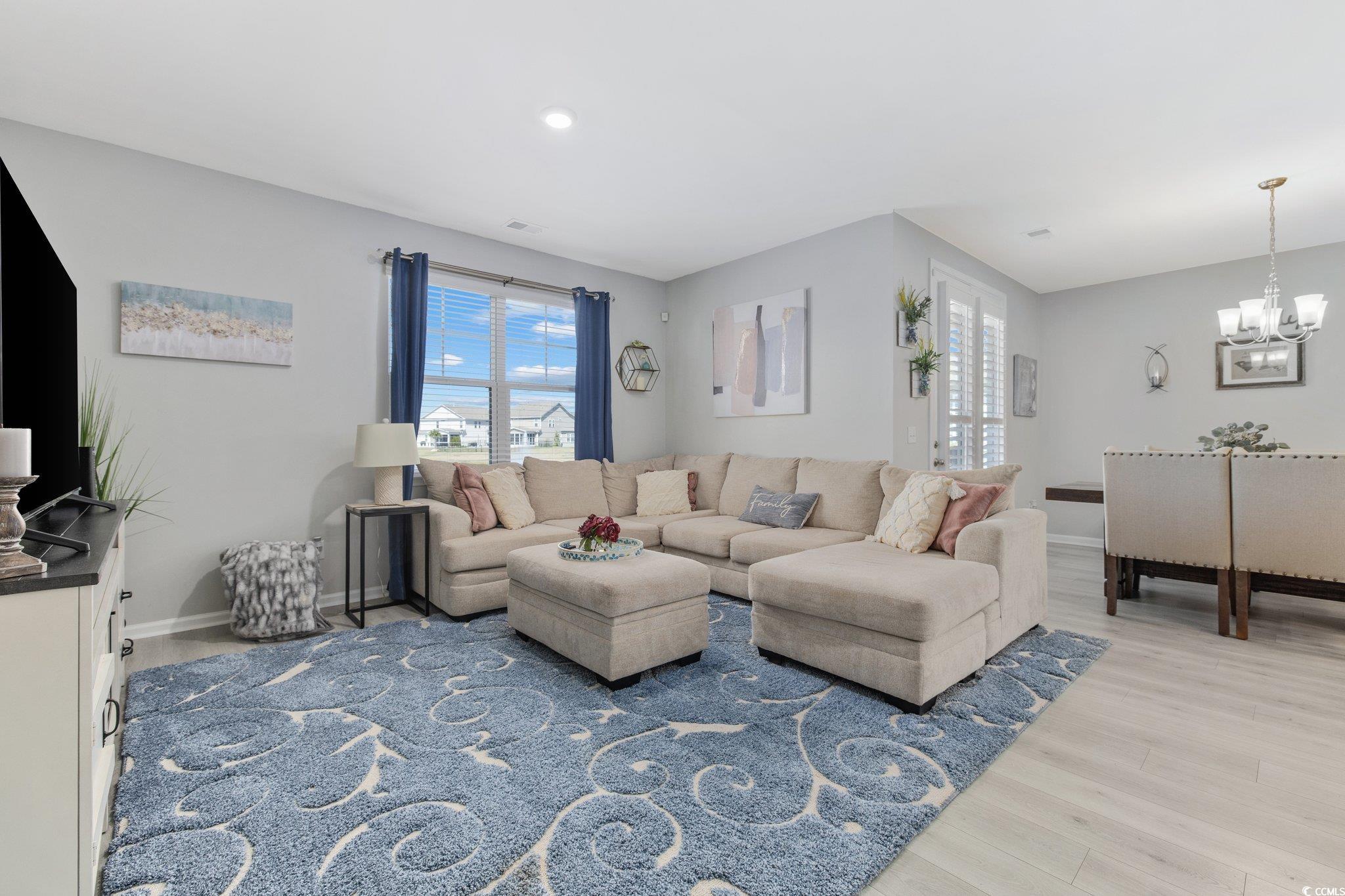 6009 Ranch View Drive Myrtle Beach, SC 29588 - Photo 13 of 40 Living room featuring baseboards, a chandelier, and light wood finished floors