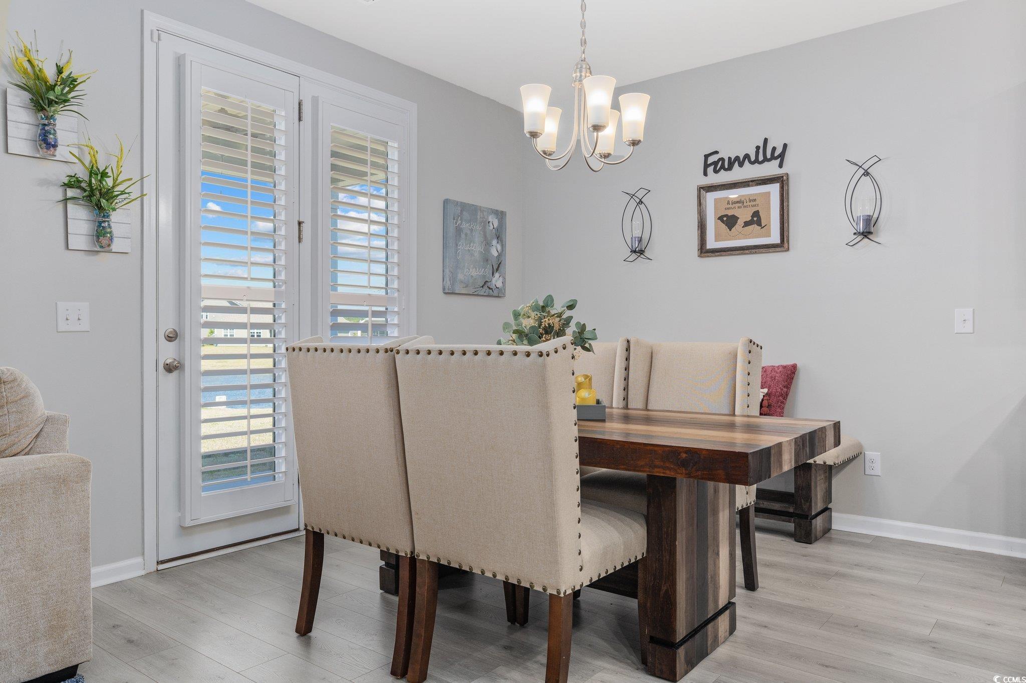 6009 Ranch View Drive Myrtle Beach, SC 29588 - Photo 14 of 40 Dining space with an inviting chandelier, baseboards, and light wood finished floors