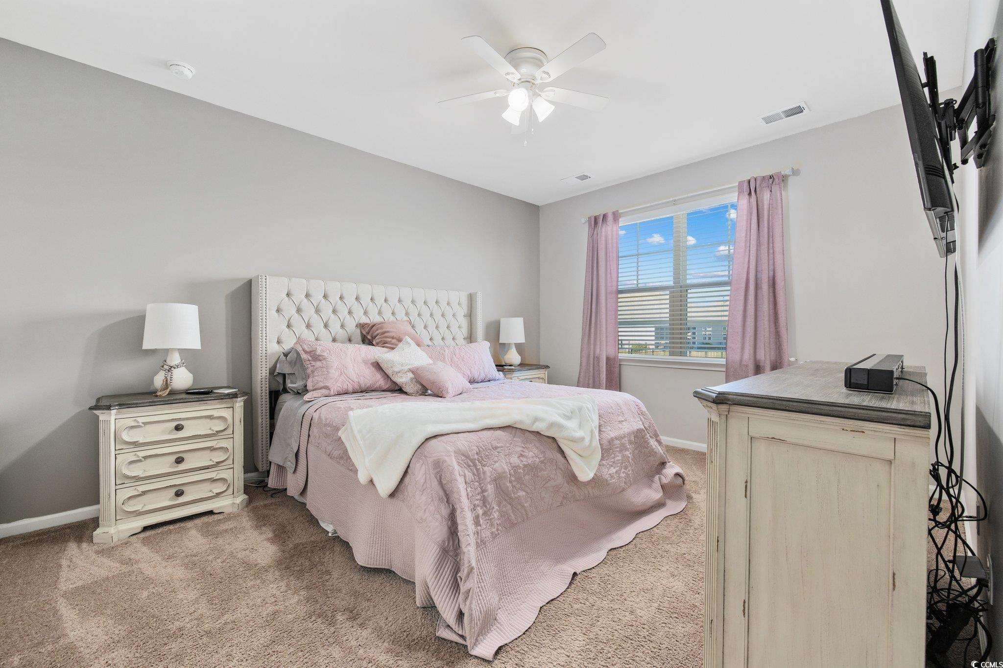 6009 Ranch View Drive Myrtle Beach, SC 29588 - Photo 16 of 40 Bedroom featuring visible vents, light carpet, baseboards, and a ceiling fan