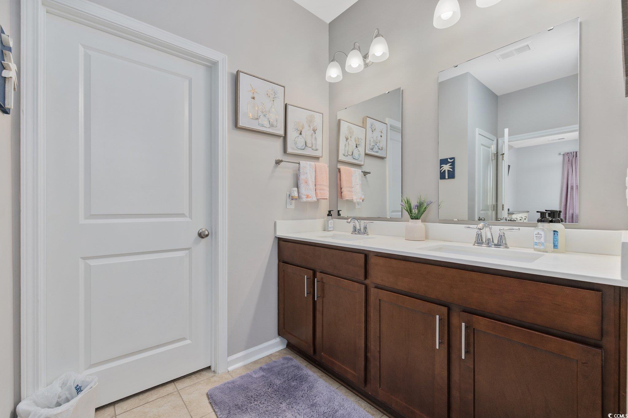 6009 Ranch View Drive Myrtle Beach, SC 29588 - Photo 19 of 40 Full bathroom with tile patterned floors, double vanity, visible vents, and a sink