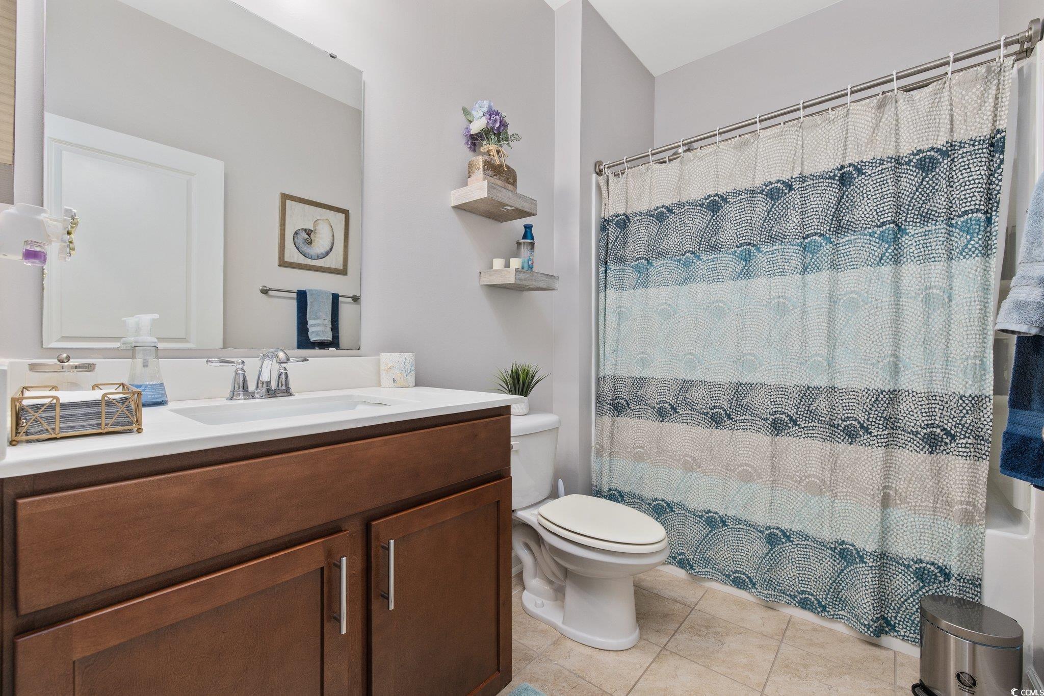 6009 Ranch View Drive Myrtle Beach, SC 29588 - Photo 23 of 40 Bathroom with vanity, tile patterned floors, curtained shower, and toilet