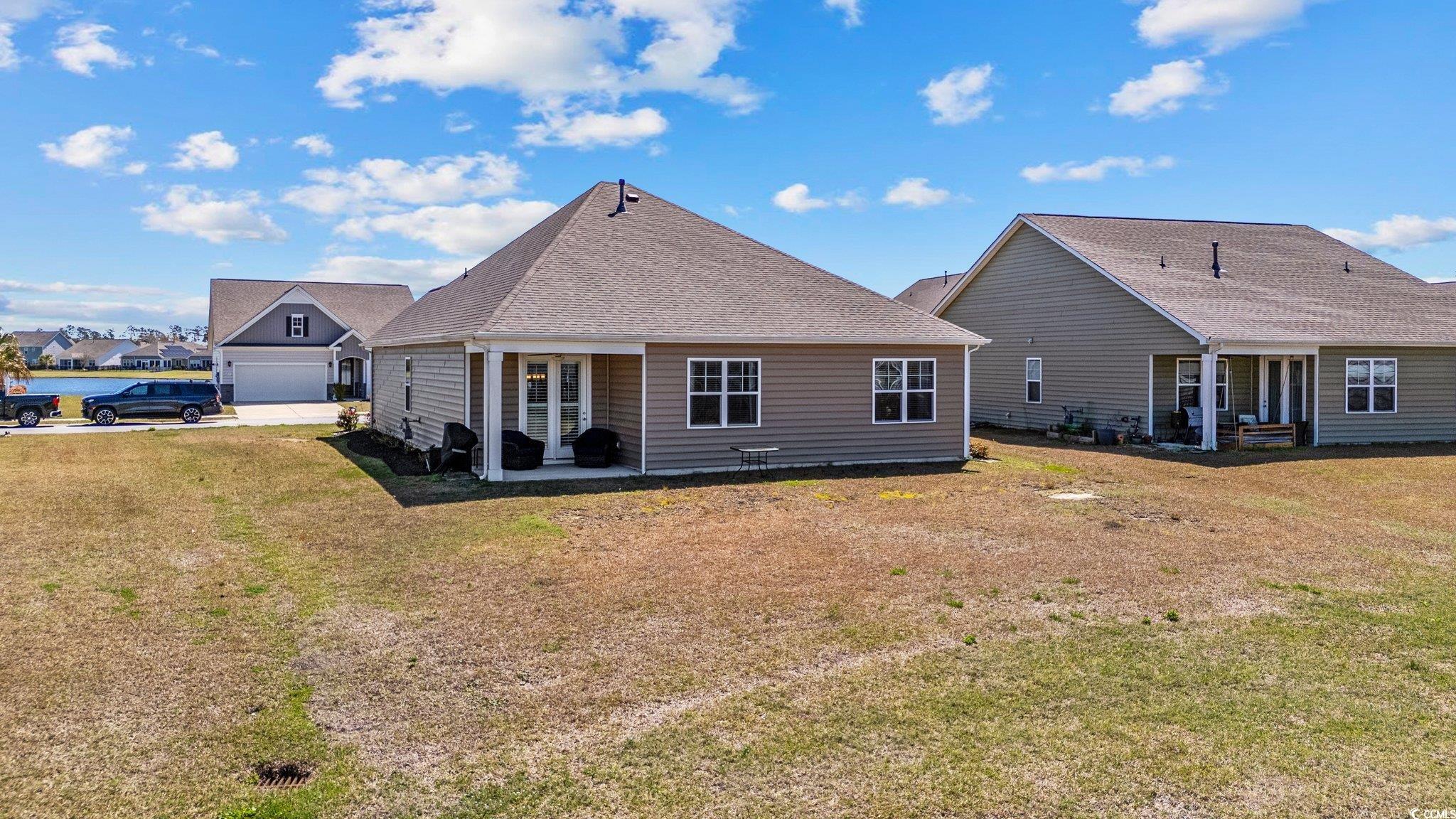 6009 Ranch View Drive Myrtle Beach, SC 29588 - Photo 27 of 40 Back of house with a lawn and a shingled roof