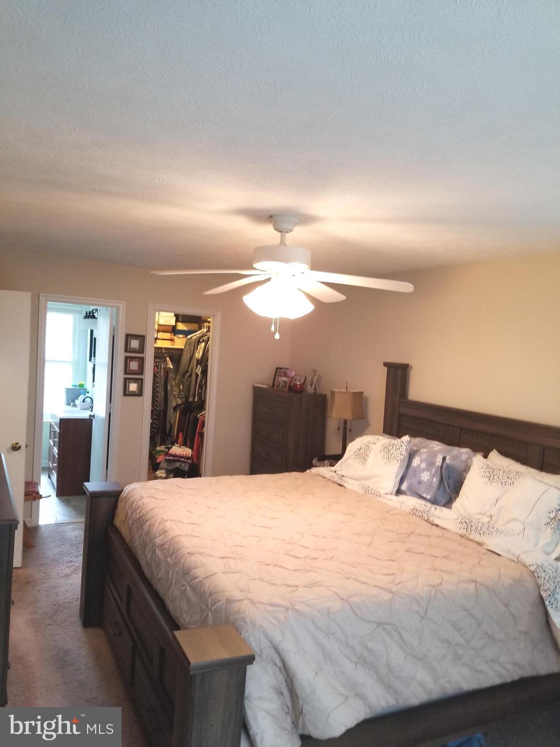 44 Buck Road Stafford, VA 22556 - Photo 11 of 30 a large bed sitting in a bedroom and a night stand