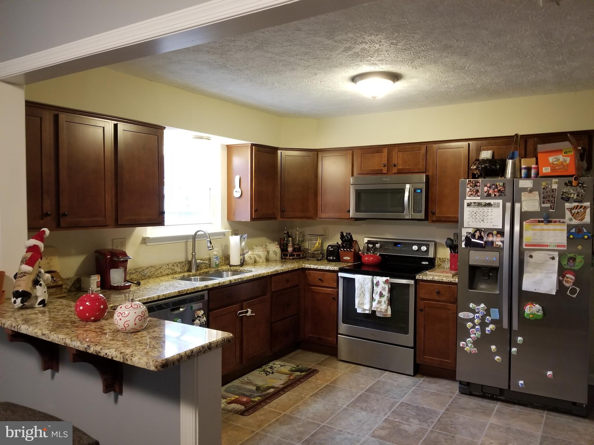 44 Buck Road Stafford, VA 22556 - Photo 6 of 30 a kitchen with stainless steel appliances kitchen island granite countertop a sink dishwasher stove and refrigerator