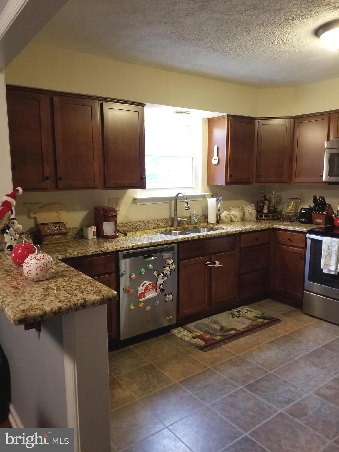 44 Buck Road Stafford, VA 22556 - Photo 7 of 30 a kitchen with stainless steel appliances granite countertop a sink stove and cabinets