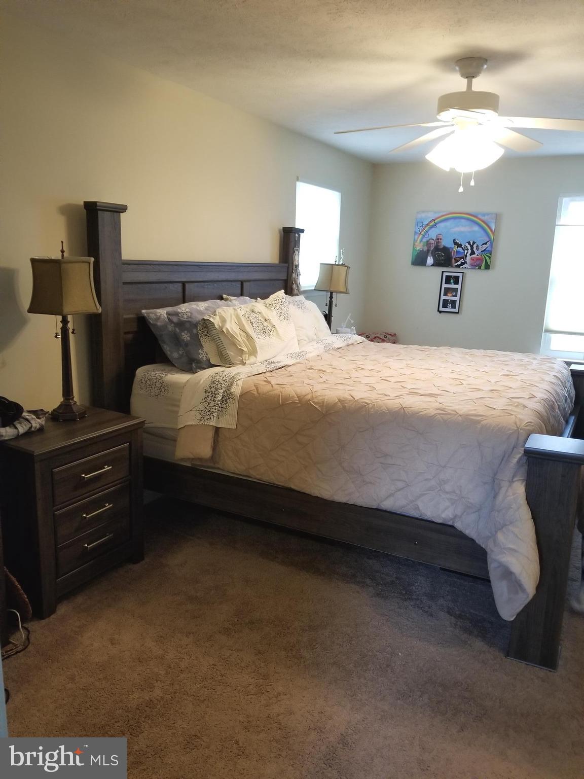 44 Buck Road Stafford, VA 22556 - Photo 10 of 30 a bedroom with a bed and a lamp on table