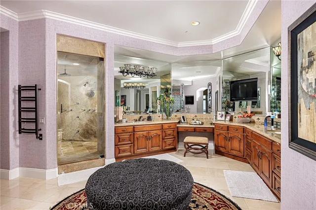 a view of a patio with a table and chairs under an umbrella with palm trees