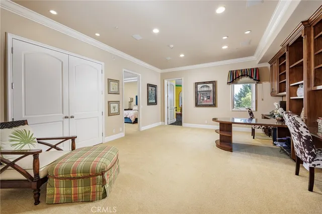 a view of a patio with couches table and chairs under an umbrella