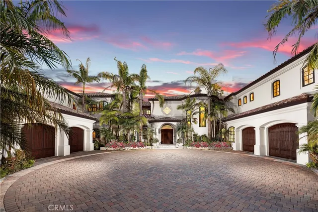 a living room with furniture a chandelier and a dining table
