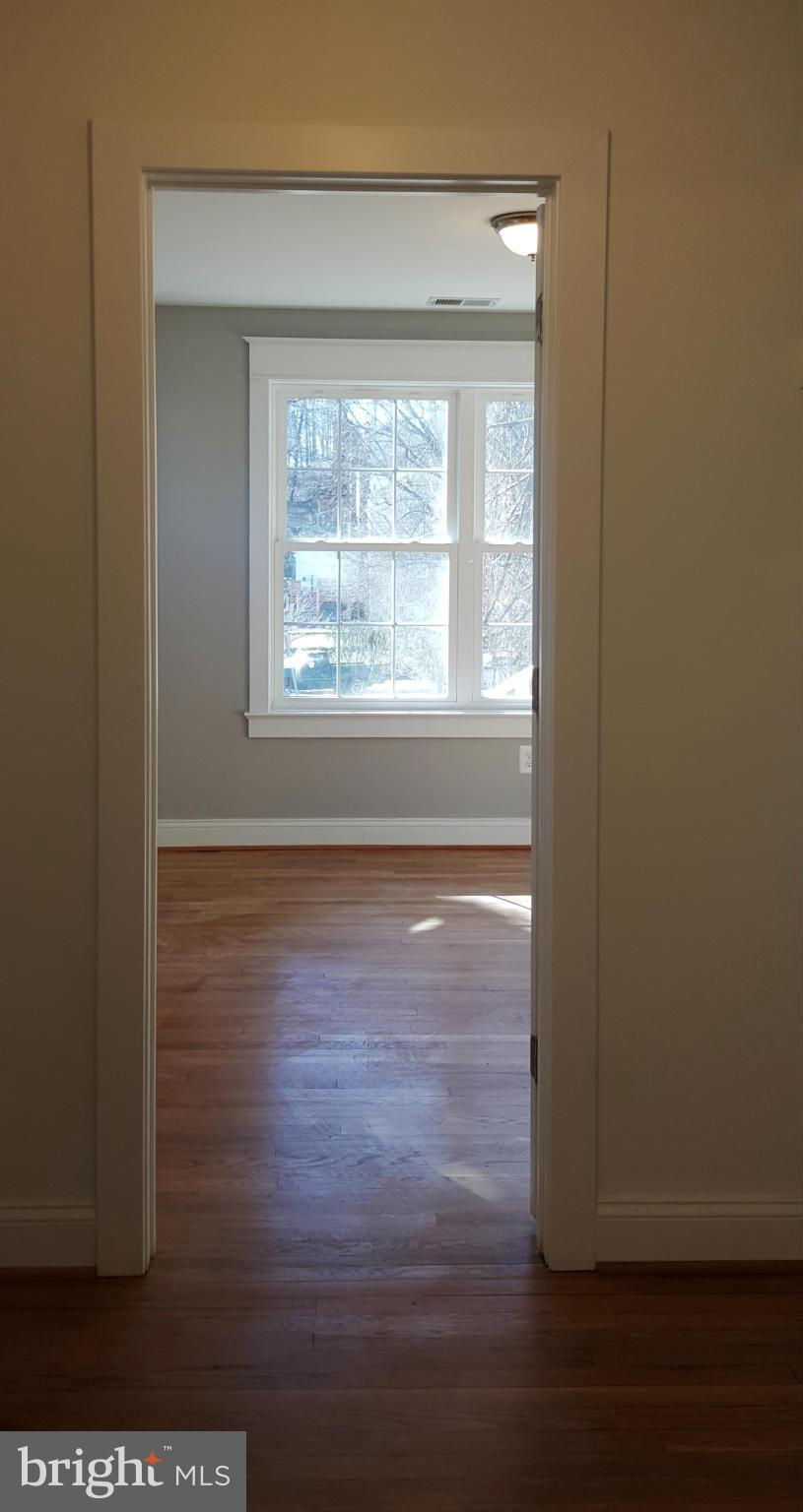 12101 Berry Street Silver Spring, MD 20902 - Photo 11 of 27 a view of an empty room with wooden floor and a window