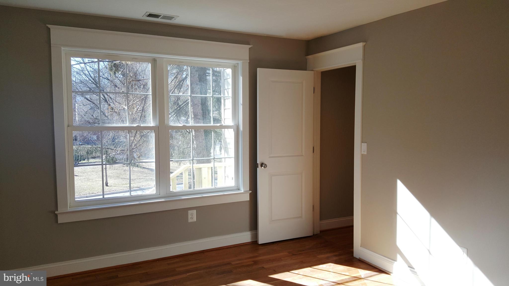 12101 Berry Street Silver Spring, MD 20902 - Photo 12 of 27 a view of an empty room with wooden floor and a window