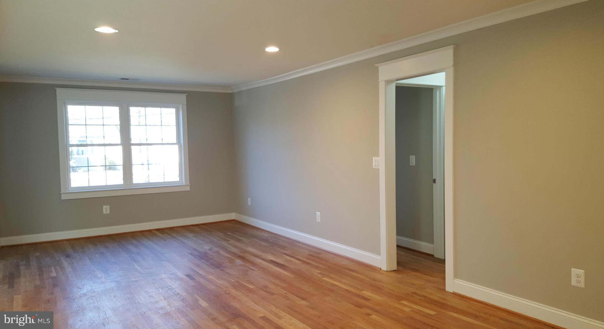 12101 Berry Street Silver Spring, MD 20902 - Photo 13 of 27 an empty room with wooden floor and windows