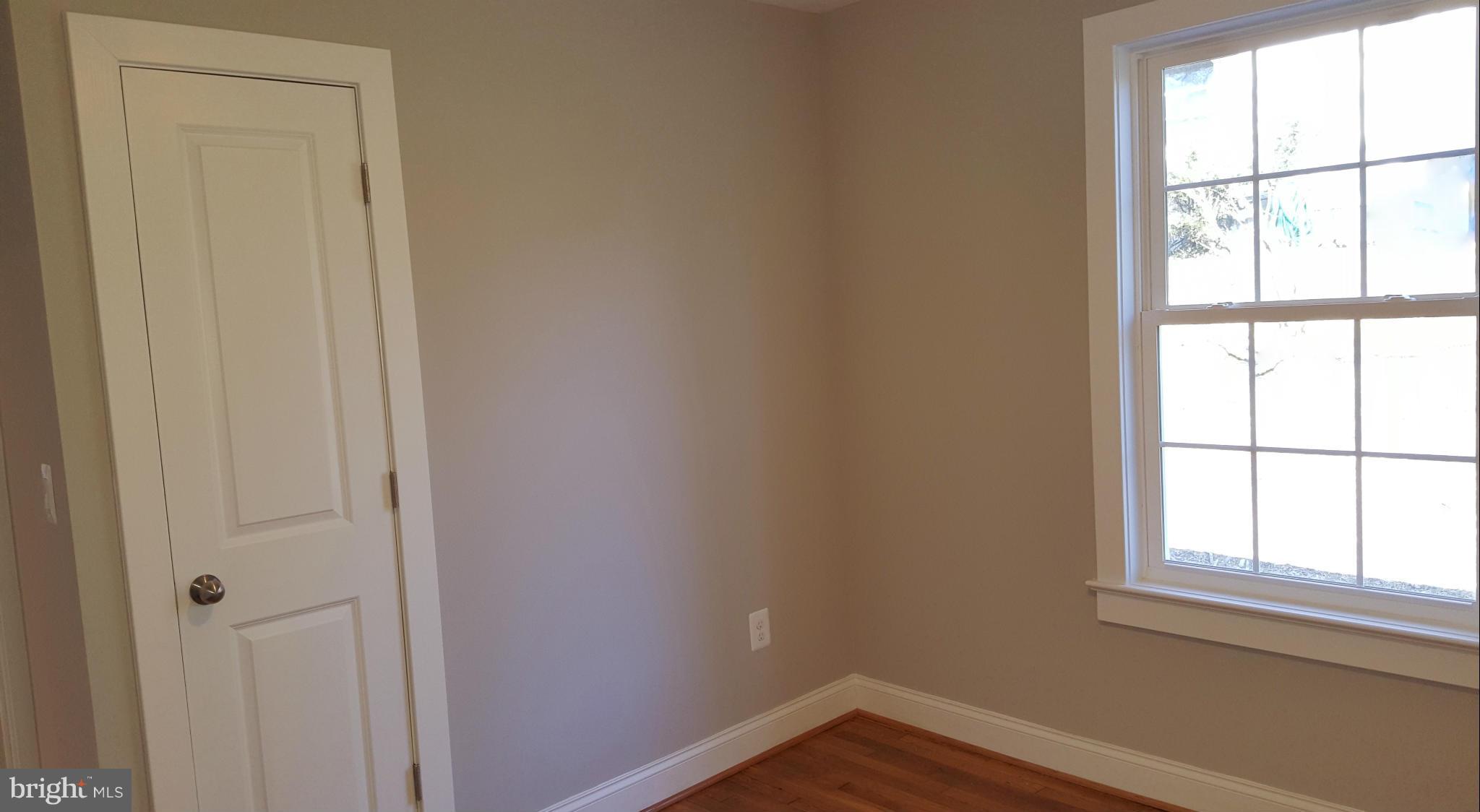 12101 Berry Street Silver Spring, MD 20902 - Photo 16 of 27 an empty room with wooden floor and windows