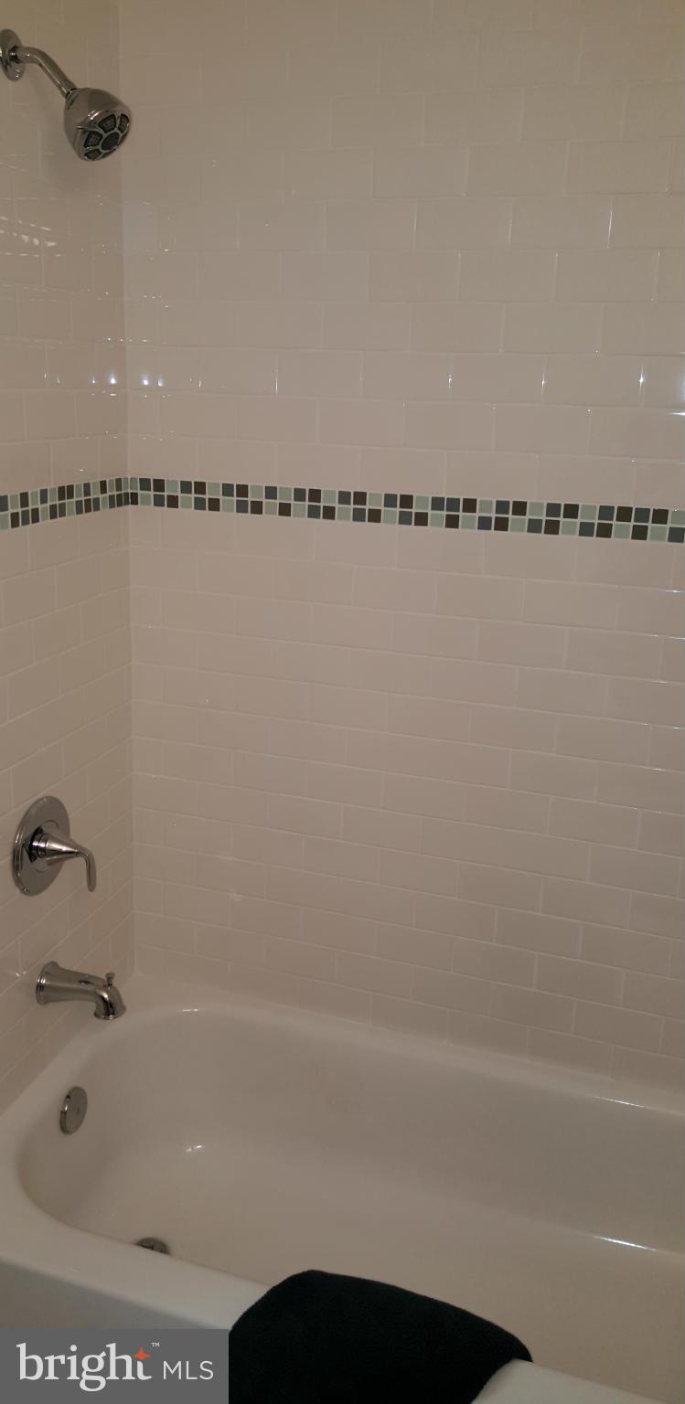 12101 Berry Street Silver Spring, MD 20902 - Photo 18 of 27 a bathroom with a bathtub and a shower