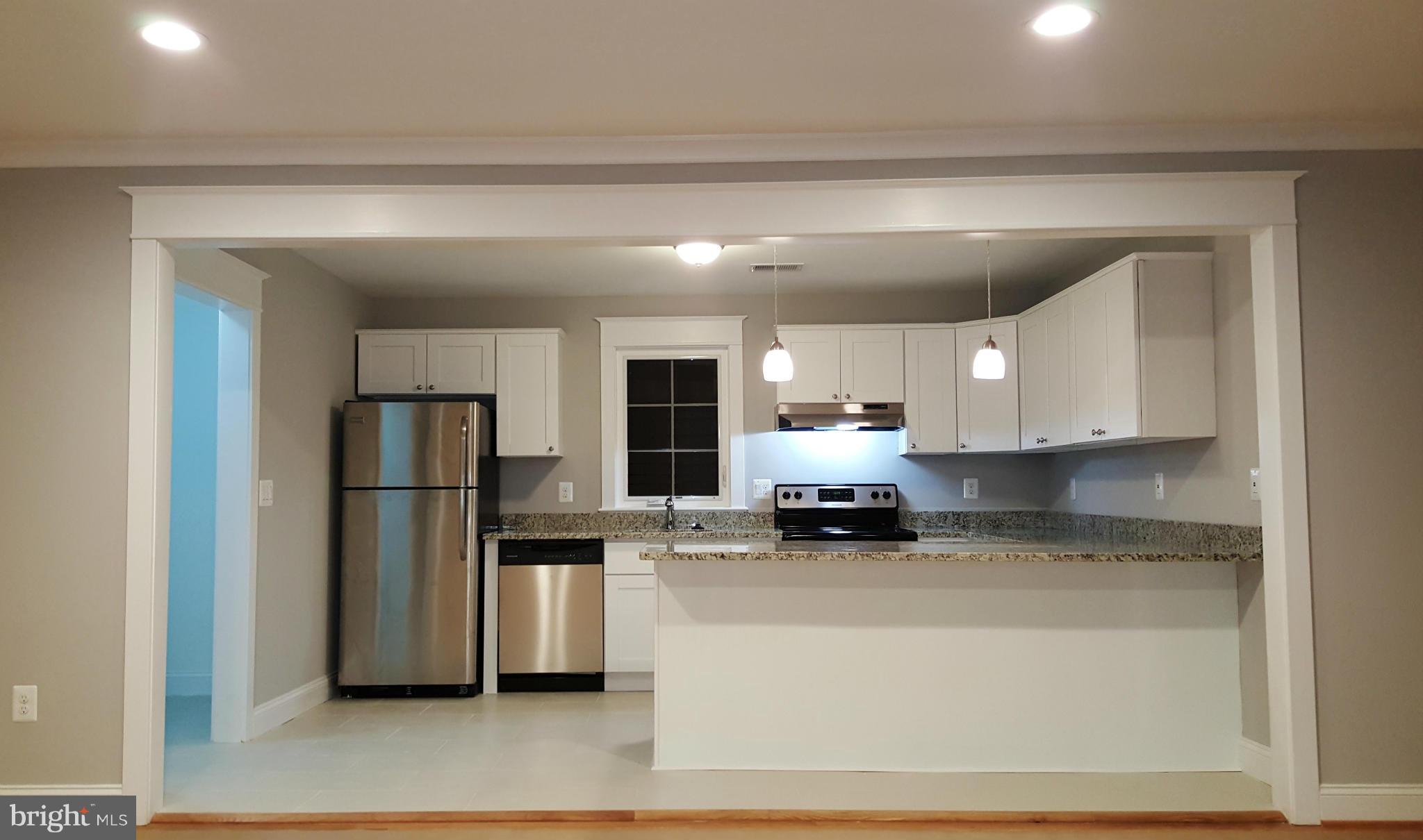 12101 Berry Street Silver Spring, MD 20902 - Photo 20 of 27 a kitchen with stainless steel appliances a refrigerator sink and cabinets