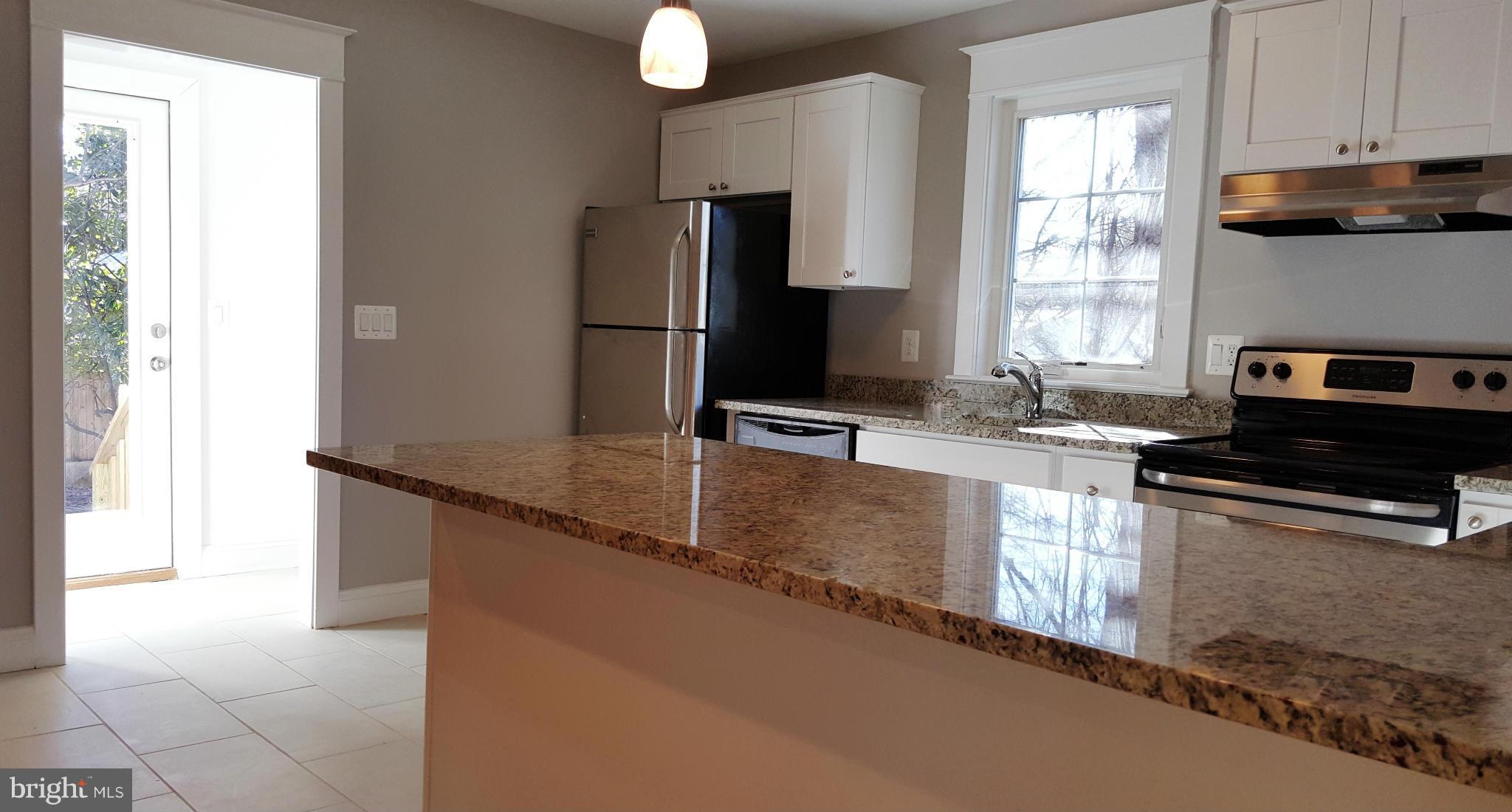 12101 Berry Street Silver Spring, MD 20902 - Photo 24 of 27 a kitchen with granite countertop a refrigerator and a sink