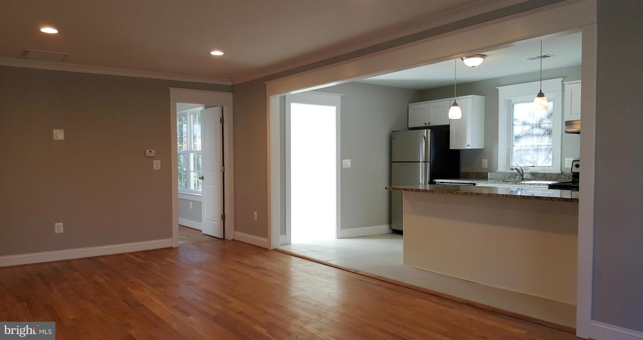 12101 Berry Street Silver Spring, MD 20902 - Photo 4 of 27 a view of a kitchen cabinets and a wooden floor