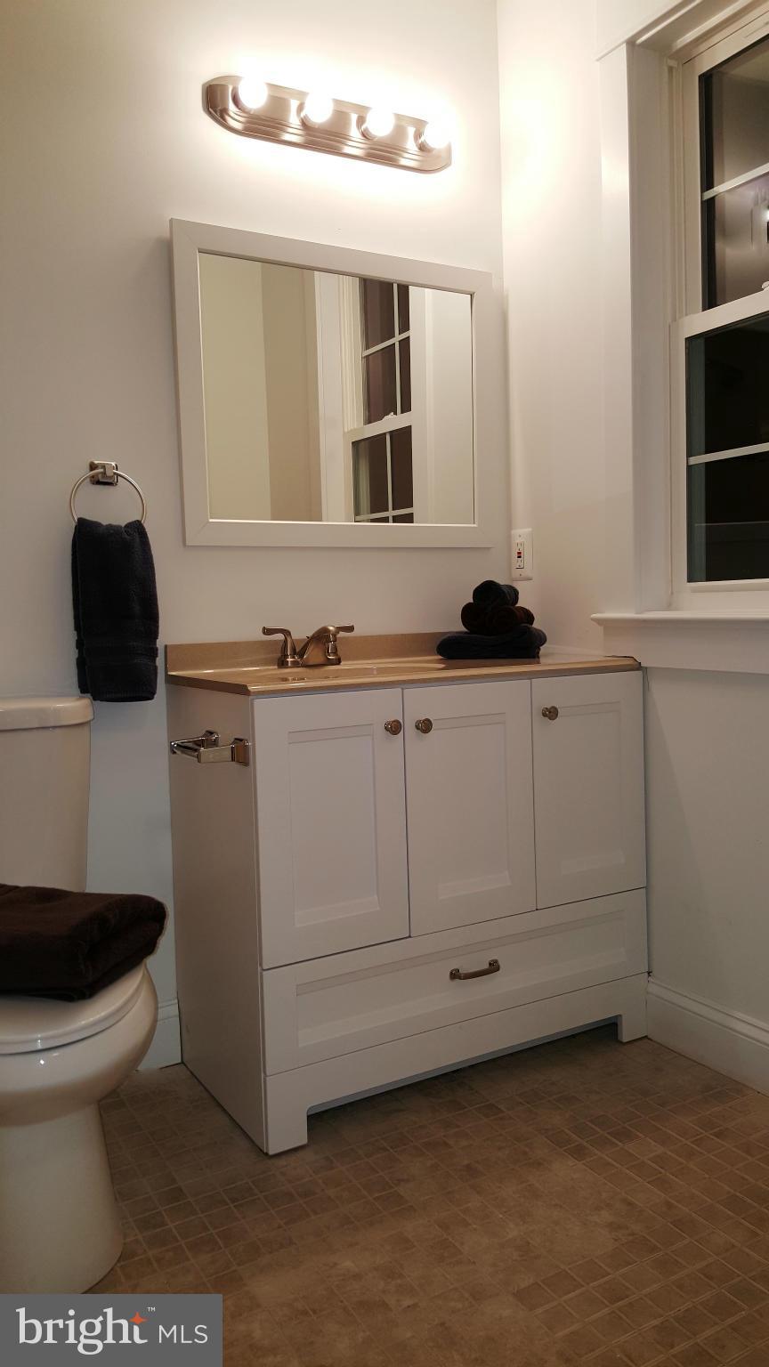 12101 Berry Street Silver Spring, MD 20902 - Photo 10 of 27 a bathroom with a sink a toilet and a mirror