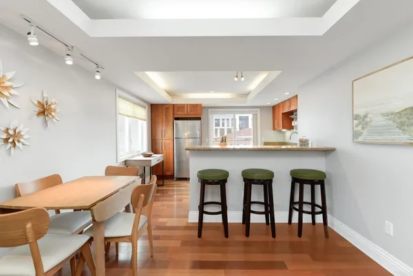 a view of a dining room with furniture and wooden floor