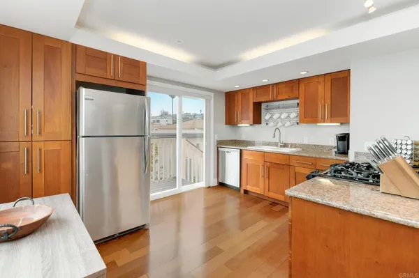 a kitchen with stainless steel appliances a refrigerator sink and cabinets