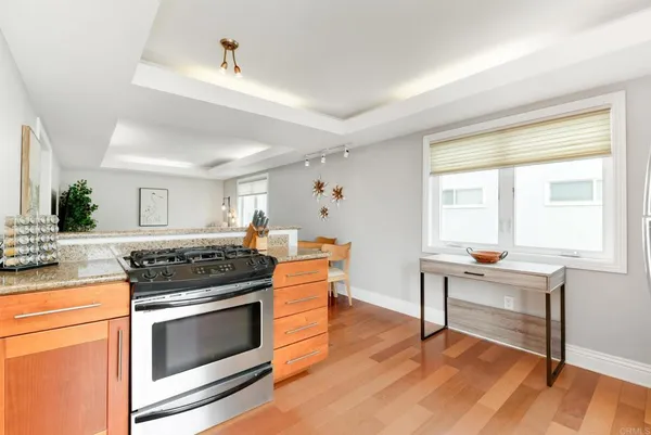 a kitchen with stainless steel appliances a stove a sink and a refrigerator