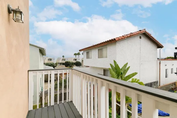 a view of a house with wooden deck and furniture