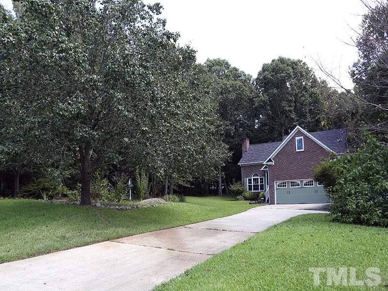 6825 Pinnacle Ridge Road Raleigh, NC 27603 - Photo 2 of 23 a front view of a house with garden