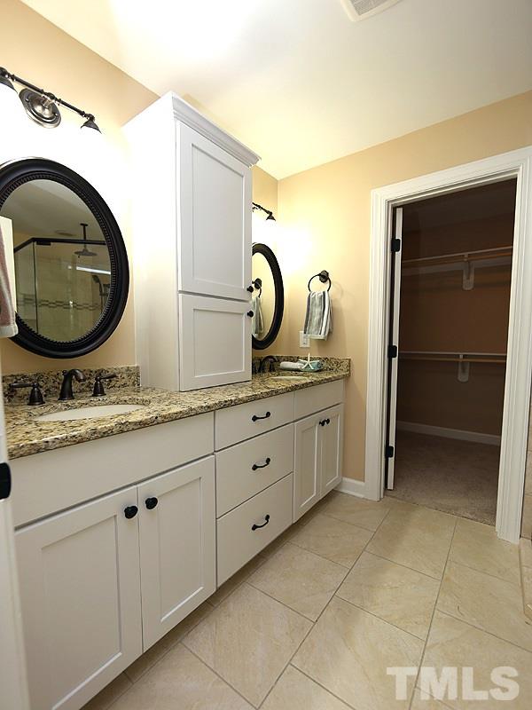 6825 Pinnacle Ridge Road Raleigh, NC 27603 - Photo 14 of 23 a bathroom with a granite countertop sink and a mirror