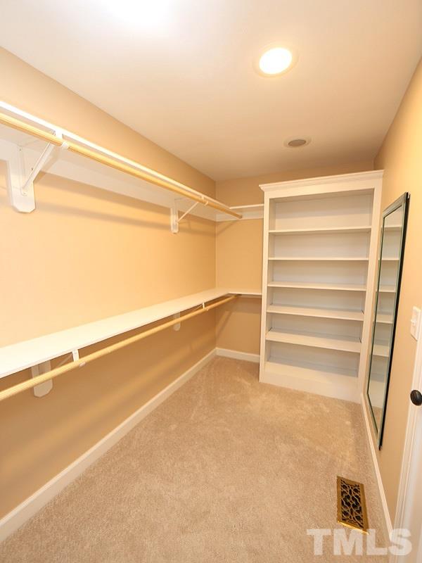 6825 Pinnacle Ridge Road Raleigh, NC 27603 - Photo 16 of 23 a view of walk in closet with empty racks