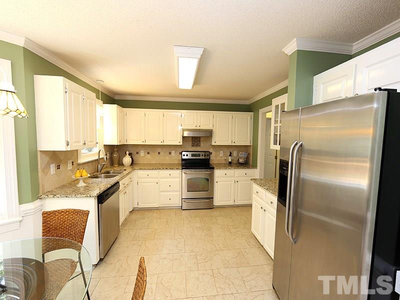 6825 Pinnacle Ridge Road Raleigh, NC 27603 - Photo 8 of 23 a kitchen with stainless steel appliances granite countertop a refrigerator and a stove top oven
