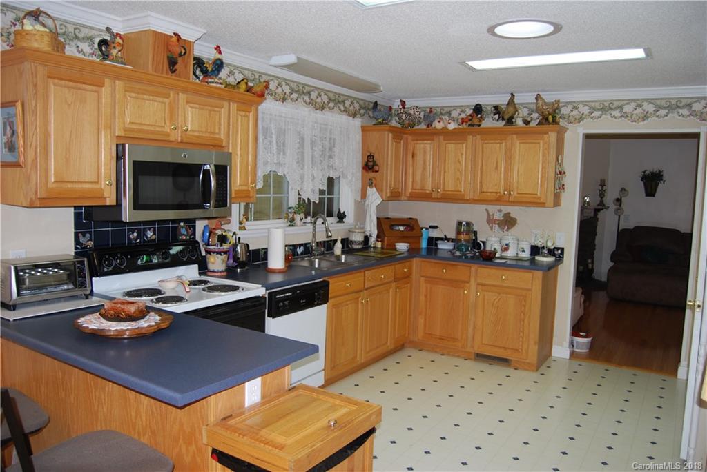 100 Hampton Road, Unit 13 Leicester, NC 28748 - Photo 5 of 33 a kitchen with a refrigerator and a stove top oven