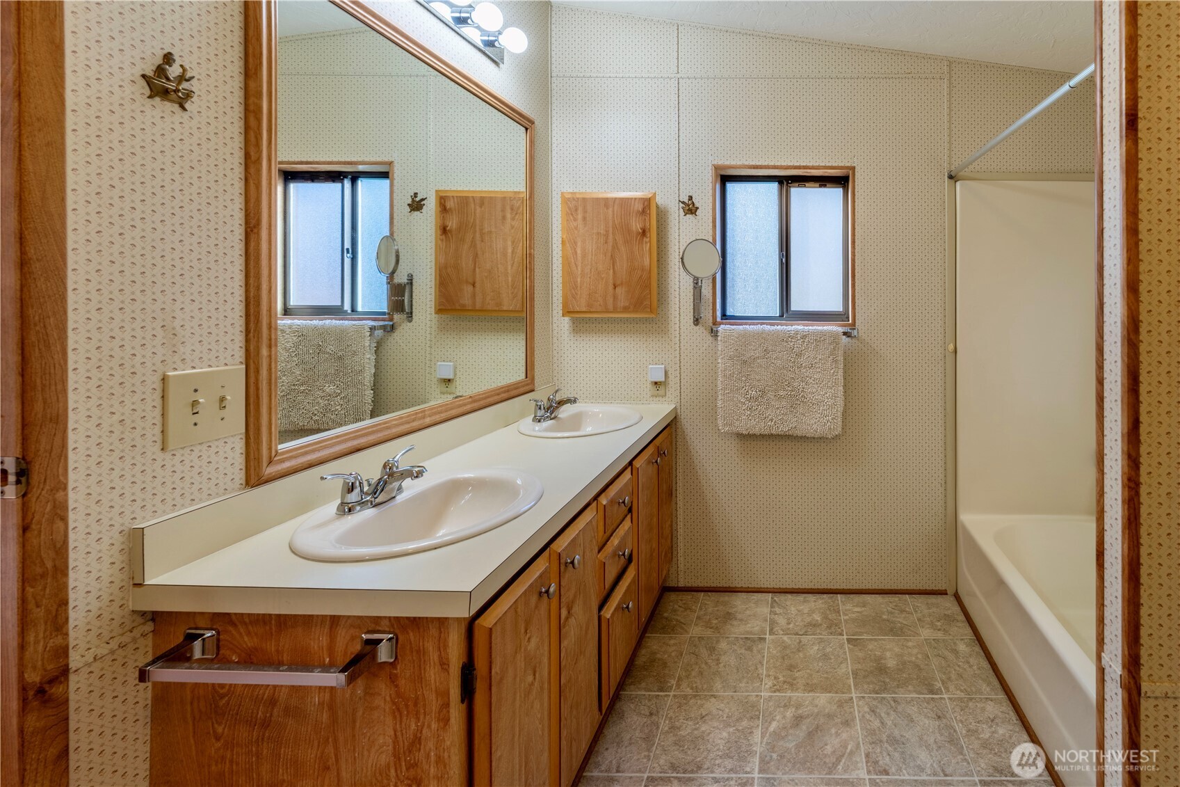 120 Fircrest Drive Sequim, WA 98382 - Photo 12 of 32 a bathroom with a double vanity sink a mirror and a