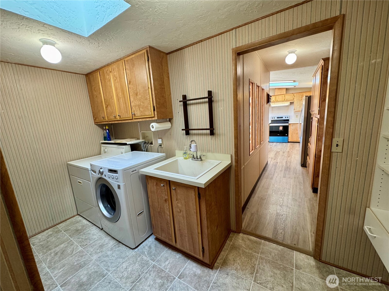 120 Fircrest Drive Sequim, WA 98382 - Photo 20 of 32 a utility room with a sink a washer and dryer