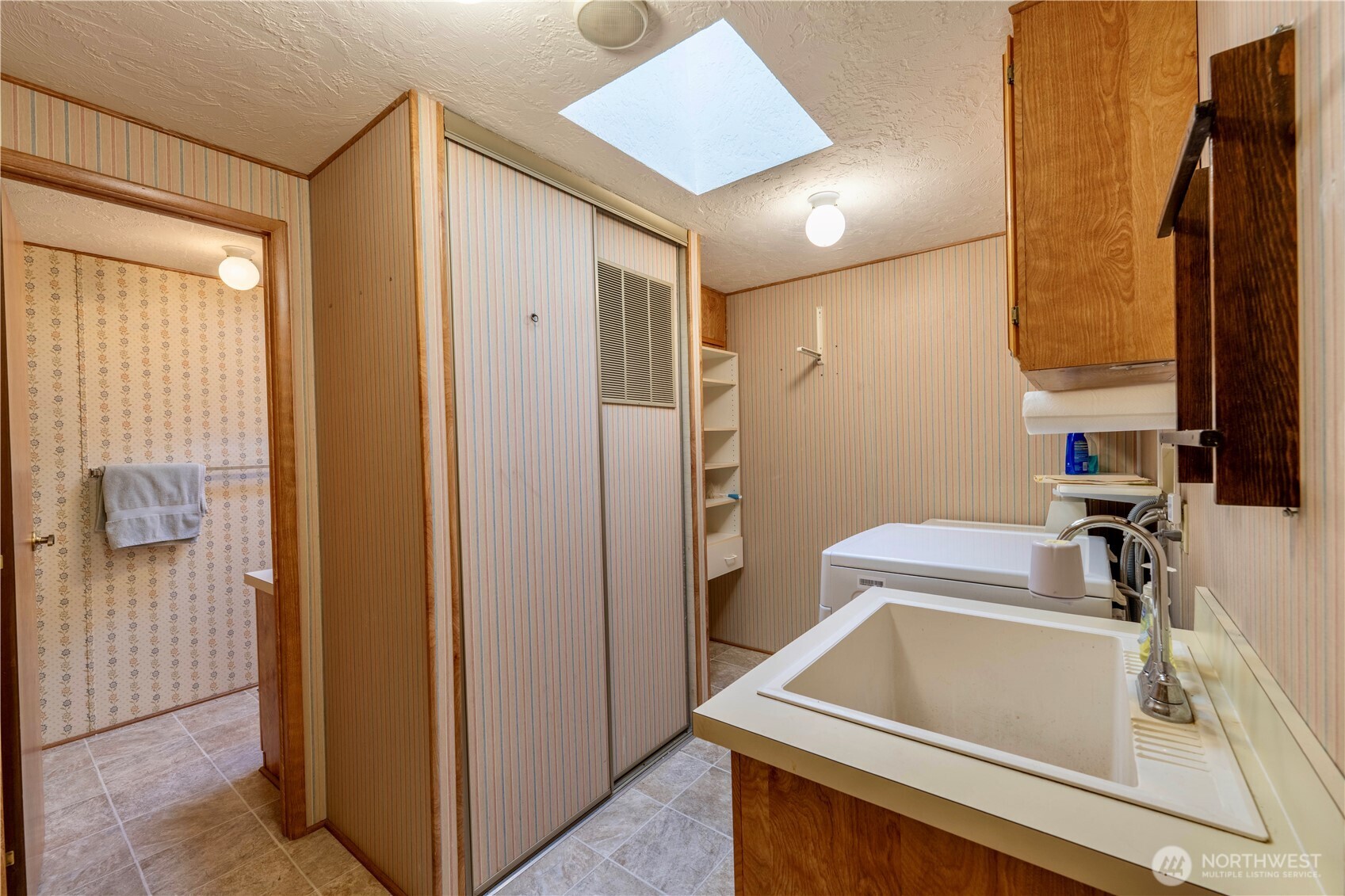 120 Fircrest Drive Sequim, WA 98382 - Photo 21 of 32 a bathroom with a sink and a large mirror