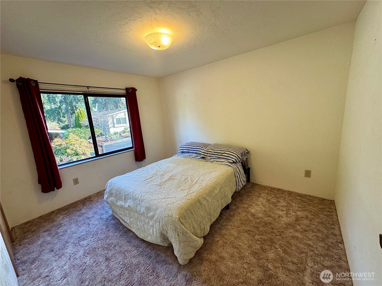 120 Fircrest Drive Sequim, WA 98382 - Photo 25 of 32 a bed sitting in a room next to a window