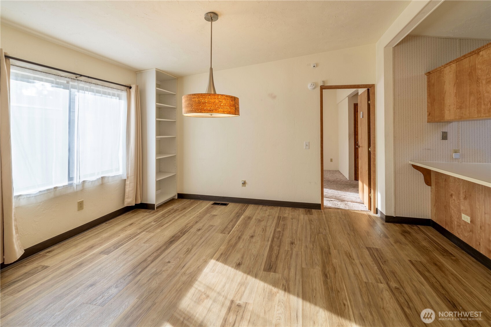 120 Fircrest Drive Sequim, WA 98382 - Photo 9 of 32 a view of an empty room with wooden floor and a window