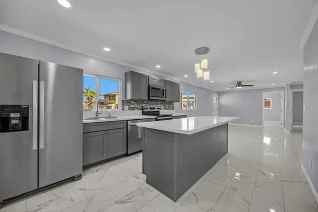a kitchen with stainless steel appliances granite countertop a refrigerator sink and cabinets