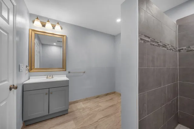 a bathroom with a sink a toilet and mirror