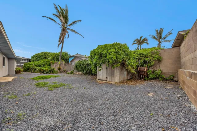 a view of a house with a yard and floor to ceiling window