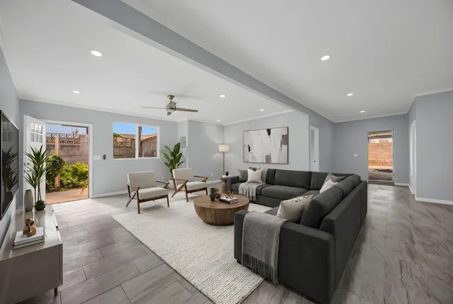 a view of empty room with wooden floor and windows