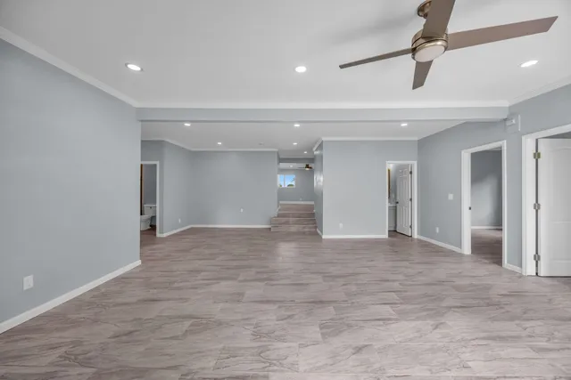 a view of a livingroom with a ceiling fan window and wooden floor