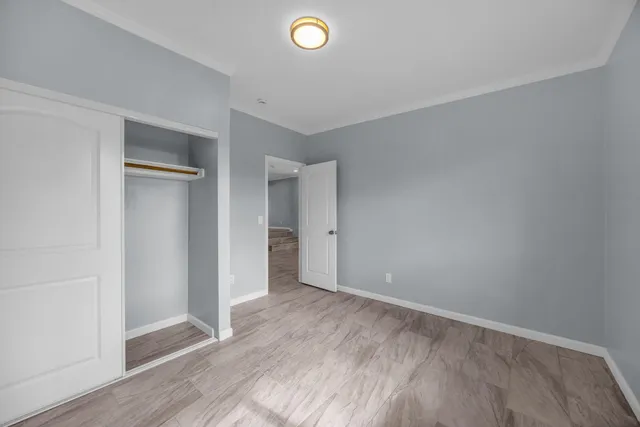 a bedroom with a bed and a large mirror