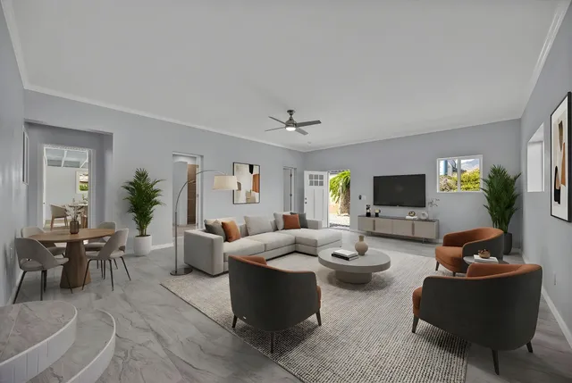 a living room with furniture a view of living room and a flat screen tv